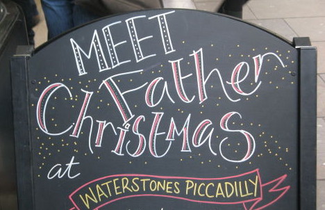 Een bord met de tekst Meet Father Christmas bij Waterstones Piccadilly